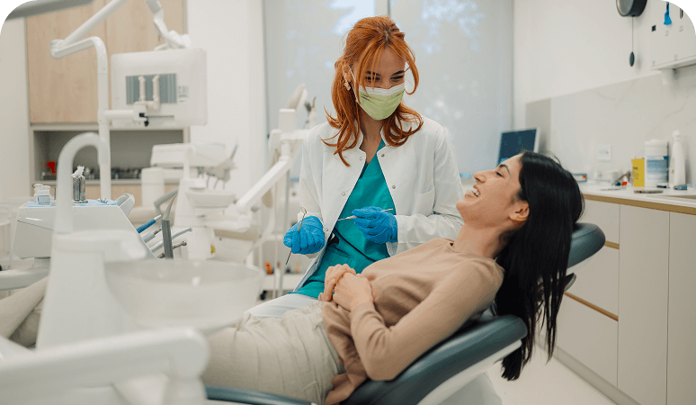 Dentist and patient smiling in clinic