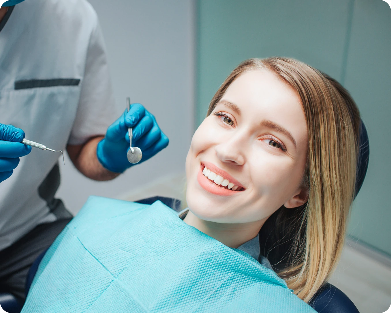 Dentist examining woman's teeth