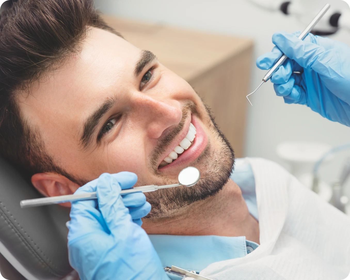 Dentist examining a smiling patient