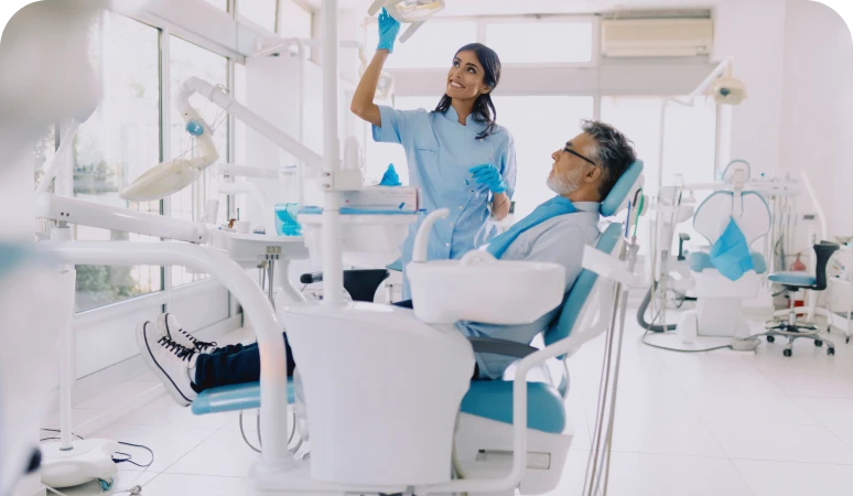 Dentist with patient in bright dental office